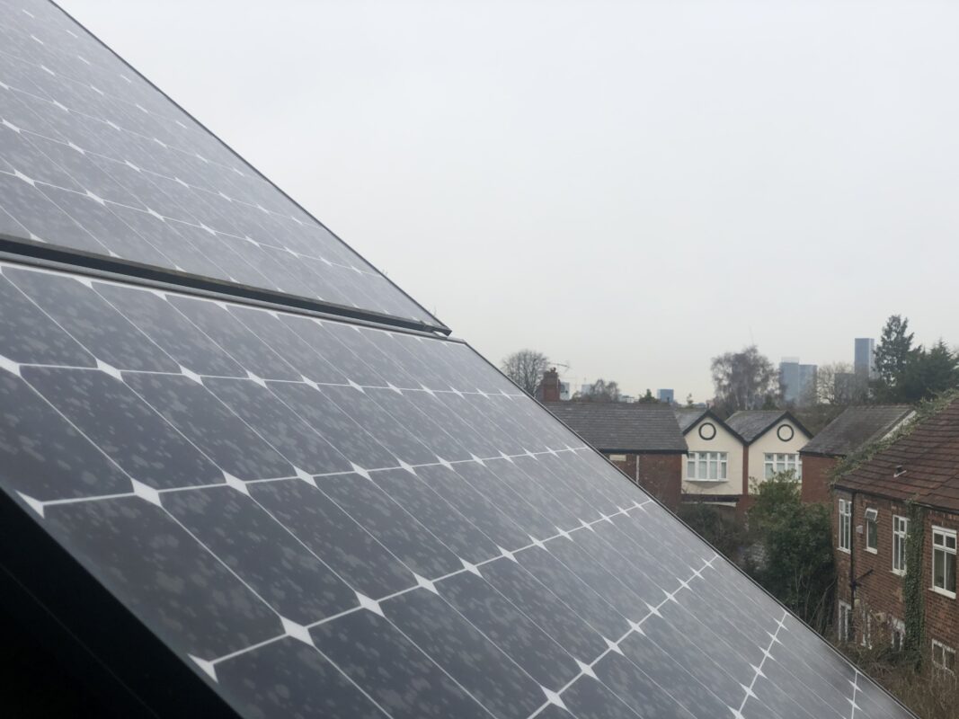 View of rooftop solar panel array looking towards Manchester