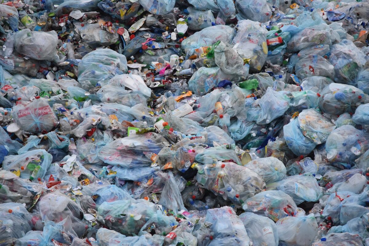 Pile of plastic waste, including bottle, tied up in plastic bags