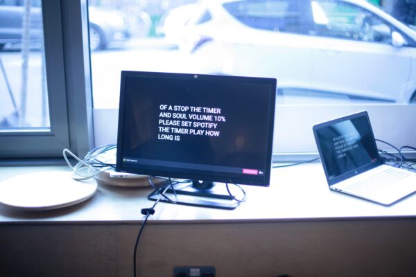 This is a photograph of a screen showing ODM's attempt to capture what people were saying out loud and output it on the ceiling – the result is not easy to understand but the people seemed to be having a conversation about Spotify
