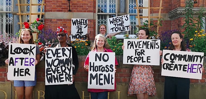 Women and girls with placards outside Stretford Public Hall