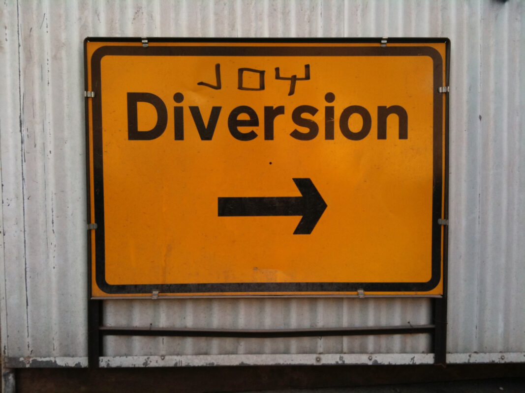 Diversion sign with Joy graffitied on the top